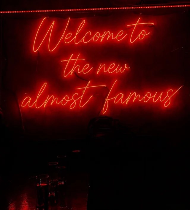 Neon script sign reading Welcome to the new Almost Famous